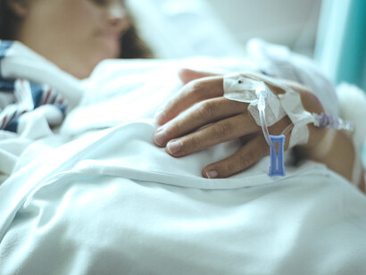 Mujer postrada en la cama de un hospital