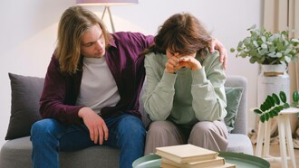 A man trying to console his friend who is dealing with a delicate and difficult situation