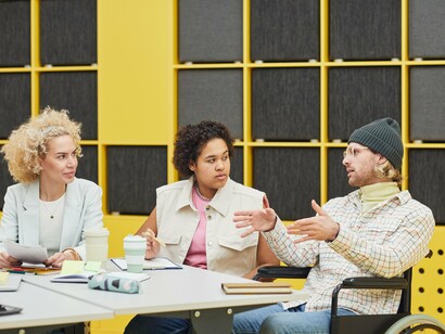 A diverse team exchanging ideas during a meeting, symbolising inclusive decision-making and stakeholder engagement
