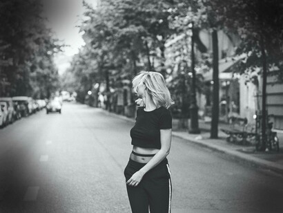 A woman looking at the road not taken and wondering whether or not it is worth going back 