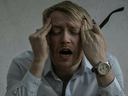 A man overwhelmed with frustration and exhaustion