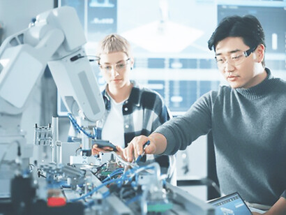 Chinese student uses a screwdriver to assemble a robotic arm, demonstrating the integration of AI and innovation within China's rapidly advancing technological landscape