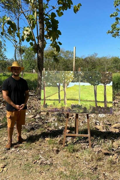 Isaac Loria,
The artist with his painting,
Untitled Landscape, 2024. Courtesy of Craig Krull Gallery