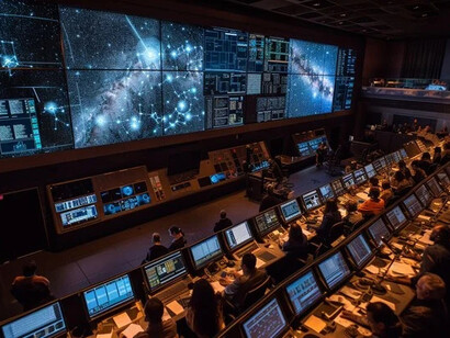 Mission control room showing human oversight of AI systems