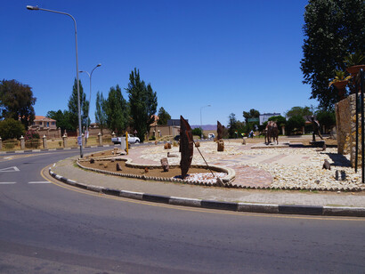 The sculptures seen in the picture celebrate Basotho history, identity, and traditional warfare, serving as public art and cultural symbolism