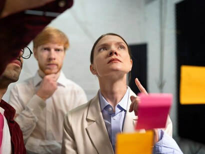 Colleagues are analyzing posts and utilizing decision-making tools like a decision tree diagram, cost-benefit analysis