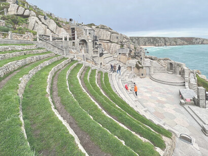 The Minack Theatre is an open-air theatre, constructed above a gully with a rocky granite outcrop jutting into the sea. The theatre is at Porthcurno, 4 miles from Land's End in Cornwall, England