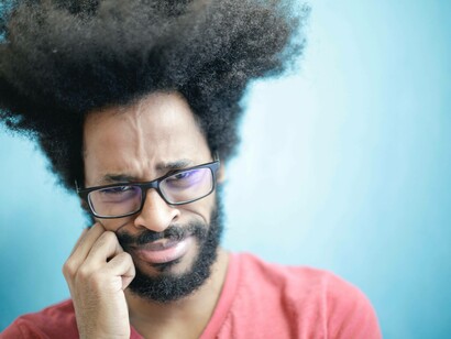 A man deeply concerned to the point of tears as he's deep in the imposter syndrome cycle