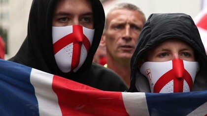 British pride from locals who are draped in the Union Jack flag and wearing masks with England colours
