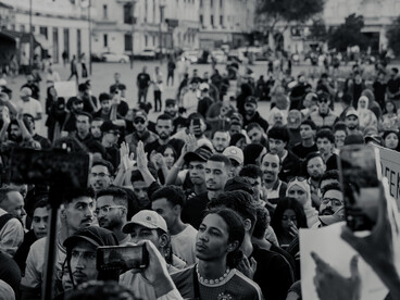 A vibrant protest crowd filling a Moroccan city street