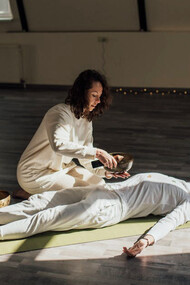 In a tranquil setting, the Reiki healer channels universal life force energy, aiming to restore harmony and balance in the recipient's energy field