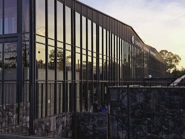The glass façade of Cineteca Nacional Chapultepec, Mexico City, Mexico, reflecting  the fusion of contemporary architecture and the surrounding natural landscape
