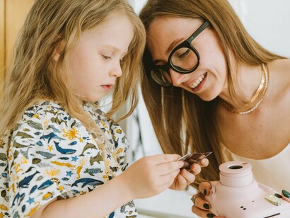 By automating production, the system allows parents to participate alongside their children rather than remaining behind a camera lens