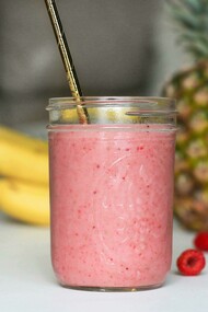 A refreshing smoothie served in a mason jar with a straw