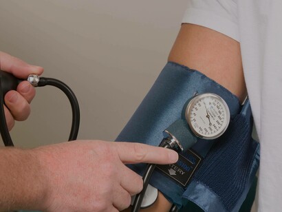 Checking the blood pressure of a patient after finding out that they have in their system co-infections