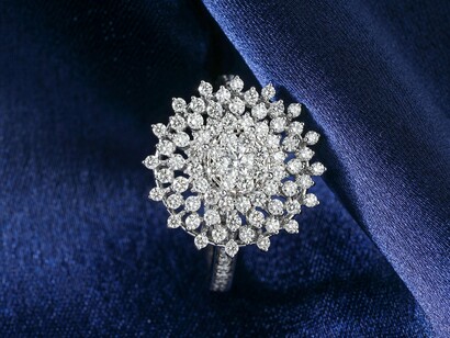 A diamond ring presented luxuriously, reflecting how natural resources are transformed into symbols of status