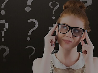 Thoughtful woman with question symbols behind