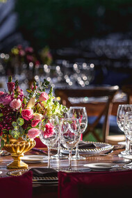 Wine glasses and beautiful rose arrangement on display