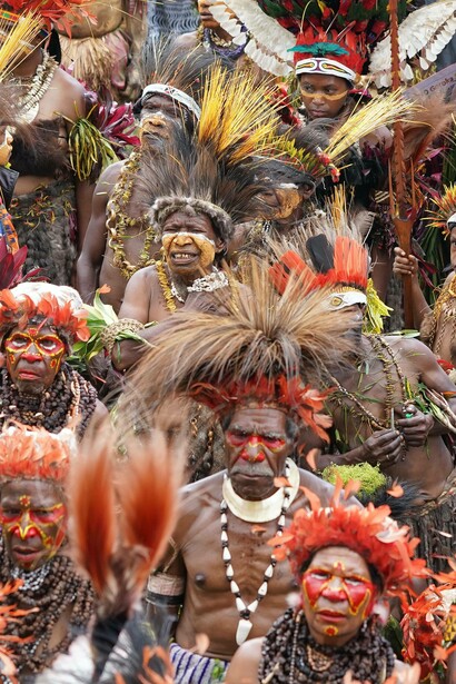 A tribe wears traditional clothes to participate in the sing sing dance, Papua New Guinea