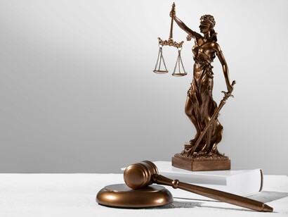 The statue of Lady Justice overlooking the gavel, reflecting justice as the guiding force behind every legal institution