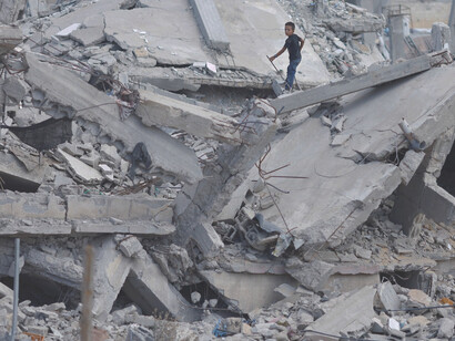 A destroyed residential block, a stark reminder of the toll political violence and military actions have taken on civilian life in war zones