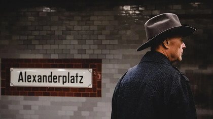 Man wearing a cowboy hat and black coat, seen from behind, Berlin, Germany