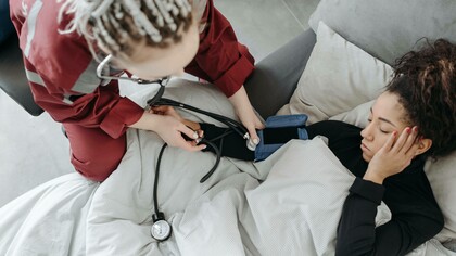 A nurse checking the blood pressure of a patient who has sickle cell disease