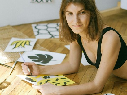 A woman using a pencil to outline her latest handmade craft