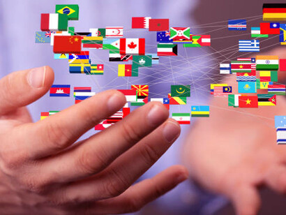 A person holding flags of different countries, symbolizing international development projects, development cooperation, and the collaboration between the Global South and North to achieve sustainable development