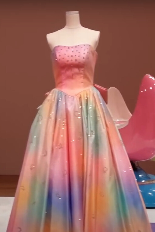 A Sailor Moon-inspired gown on display at the Sailor Moon museum with a pastel gradient, flowing silhouette, and delicate embellishments that resemble the ethereal aesthetic of Princess Serenity’s iconic dress