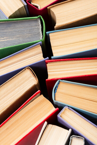 Distintos libros con tapas de colores en una mesa. La moda y la literatura se han representado mutuamente a lo largo de la historia