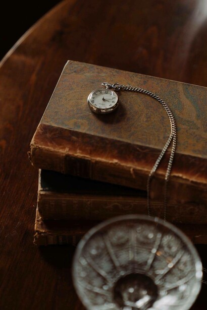 Ancient books with a hand watch