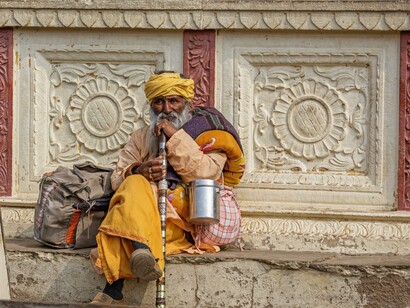 An elderly man sitting and thinking. Karma is often used to instigate fear in humans to follow a set of rules in society upon failing which there shall be repercussions, mostly in the form of re-birth