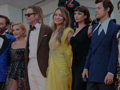 Director of Don't Worry Darling, Olivia Wilde (yellow dress), is with her cast on the red carpet