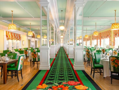 The Grand Hotel’s dining room adorned with floral accents and elegant furnishings, symbolizing the sophistication of the hotel’s culinary traditions