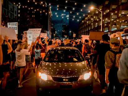 Protesters take to the streets in an anti-racism demonstration, raising banners that call for equality, freedom, and human rights