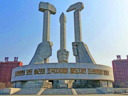 Juche symbol statue in North Korea with the slogan: 'Long live the Workers' Party of Korea, the organizer and guide of all victories of the Korean people!' - translated