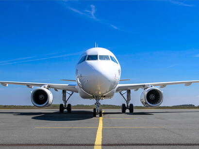 An airplane on the runway under clear skies, representing the Kingdom’s future-oriented vision for aeronautics