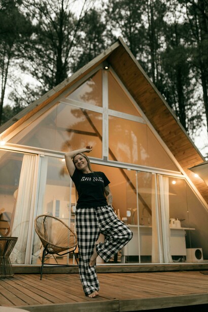 Serene mountain scenery surrounding a modern wooden A-frame cabin, reflecting a calm offline lifestyle focused on nature, mindfulness, and slow travel