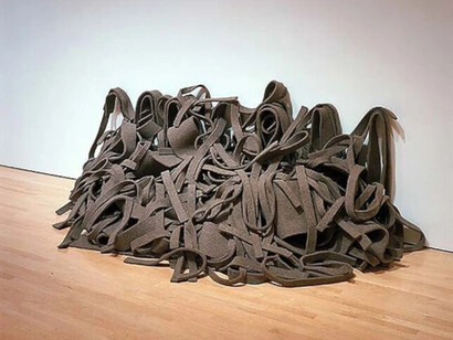 Robert Morris, Untitled (Tangle), 1967, industrial felt, variable forms and dimensions. This piece is a key example of Morris's exploration of "Anti-Form" principles, which he articulated in a 1968 essay. Rather than imposing a rigid form on the material, Morris allowed the felt to determine its own shape through natural processes like hanging, draping, and tangling. The work highlights the inherent qualities of the industrial felt, emphasizing its weight, flexibility, and texture. The process of cutting and arranging the material is also central to the artwork's function