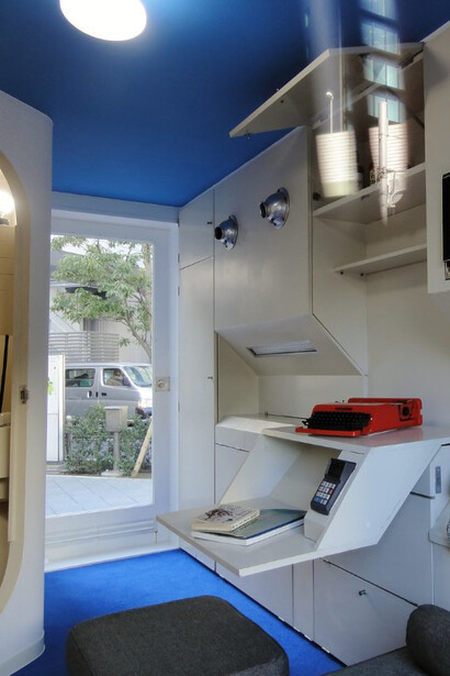 Interior view of a Nakagin Capsule Tower unit displayed near Roppongi Hills Mori Tower in Tokyo, Japan