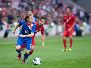 Luka Modrić of Croatia (L) and João Moutinho of Portugal (R) battle for possession during the Croatia vs. Portugal match on 10 June 2013