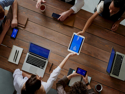 A group of people gathered at a table, talking, collaborating, and networking