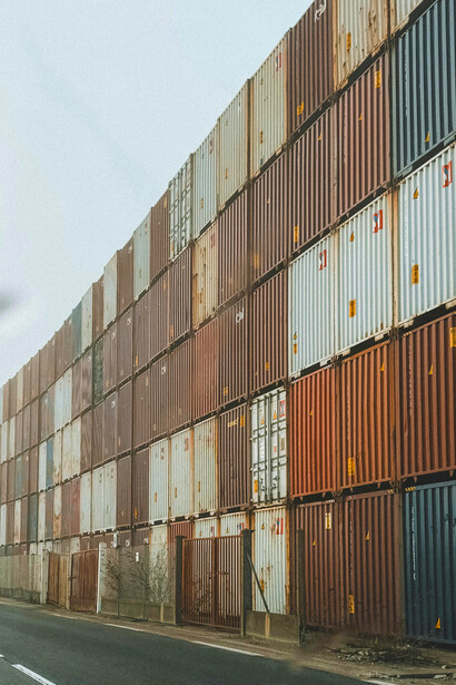 Stacked shipping containers at a freight yard ready for transport