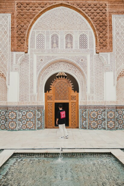 Man exploring Ben Youssef Madrasa in Marrakesh, Morocco