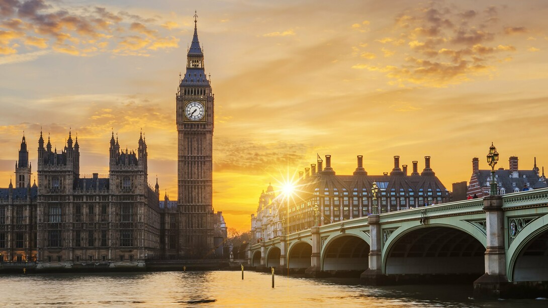 A golden sunset casting long shadows over Westminster and the Thames, representing the fading glow of Britain’s former global authority