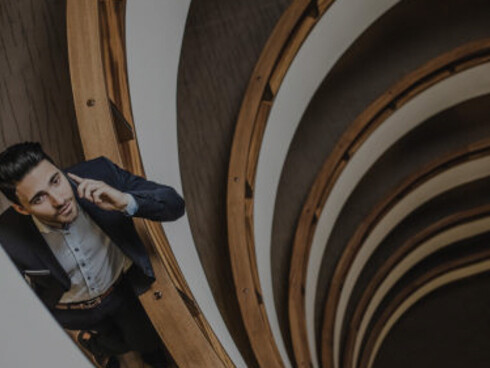 A businessman stands in the corridor, symbolizing innovation, collaboration, and entrepreneurial ventures in the business world