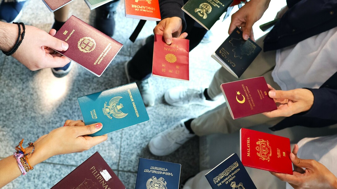 Passports of Wikimania delegates from 11 different countries, reflecting global diversity in mobility and access