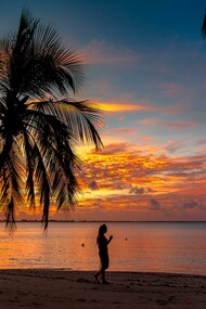 Sunset serenity on a Maldives beach with a lone silhouette