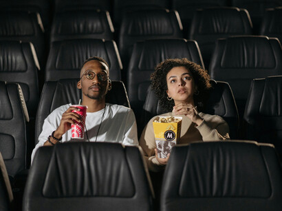 People watching a movie in a cinema directed by artificial intelligence